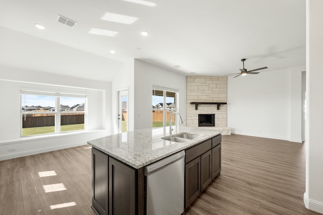 kitchen featuring light hardwood / wood-style floors, stainless steel dishwasher, plenty of natural light, and sink