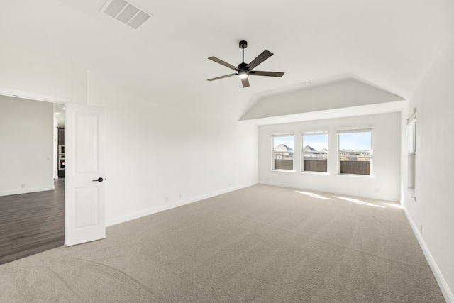 carpeted spare room with ceiling fan and lofted ceiling