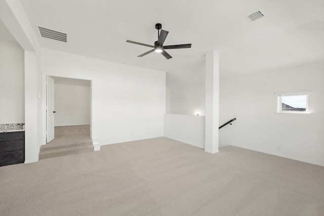 unfurnished living room featuring light colored carpet and ceiling fan