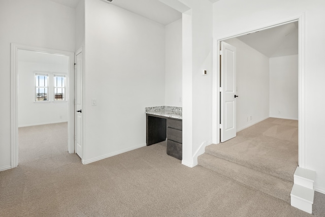 corridor with light colored carpet