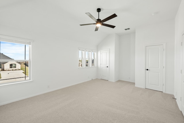 carpeted empty room with ceiling fan and lofted ceiling