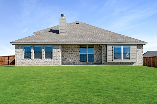 rear view of house with a lawn