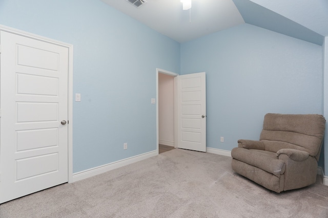 living area with light colored carpet, vaulted ceiling, and ceiling fan