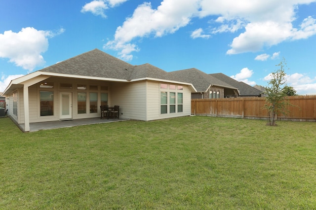 back of house featuring a patio and a lawn