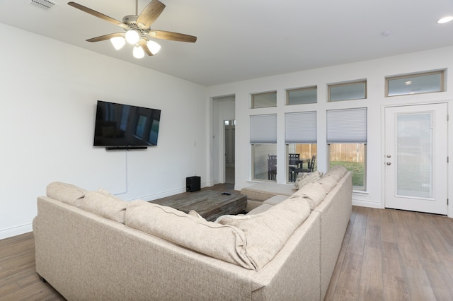 living room featuring ceiling fan and hardwood / wood-style flooring