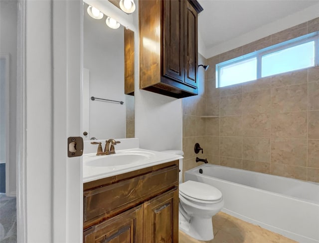 full bathroom featuring tile patterned flooring, vanity, toilet, and tiled shower / bath