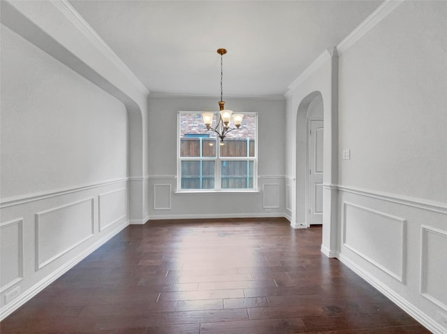 unfurnished dining area featuring a chandelier, dark hardwood / wood-style flooring, and ornamental molding