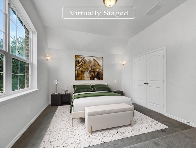 bedroom featuring carpet floors and lofted ceiling