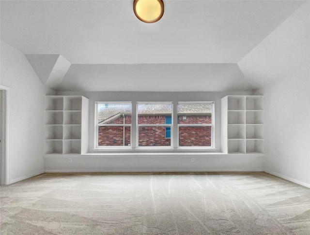 bonus room featuring carpet and vaulted ceiling