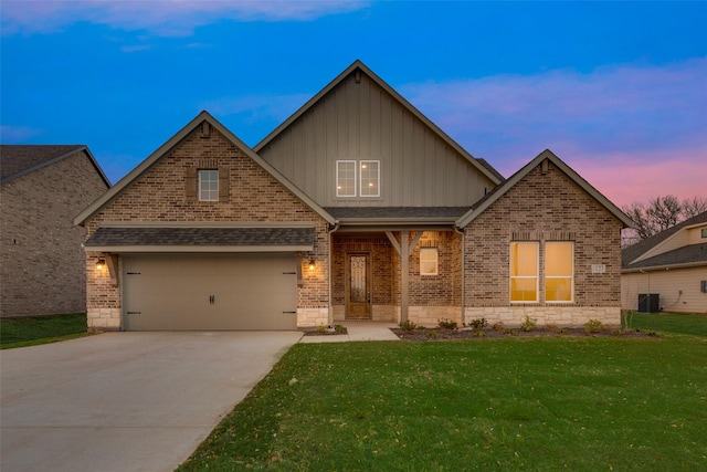 craftsman house featuring a garage, central AC unit, and a lawn