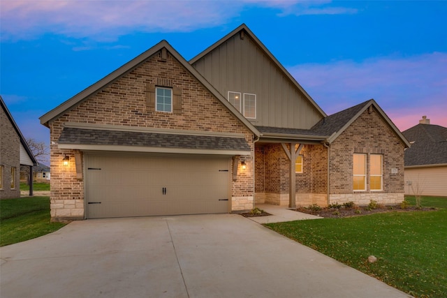 craftsman-style home featuring a lawn and a garage