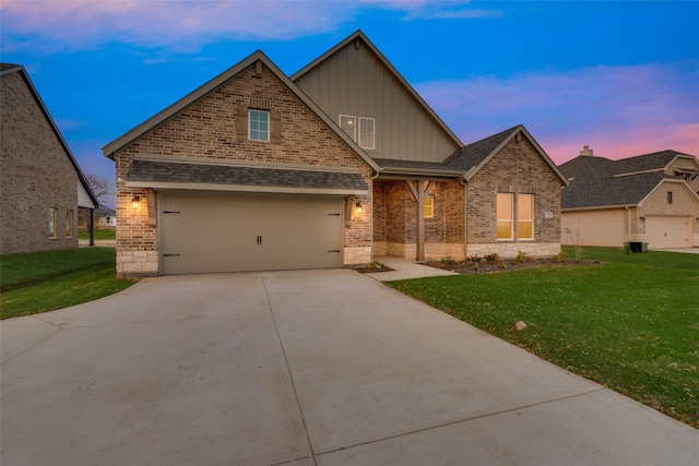 craftsman-style house featuring a yard and a garage