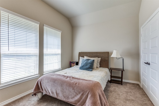 carpeted bedroom featuring lofted ceiling