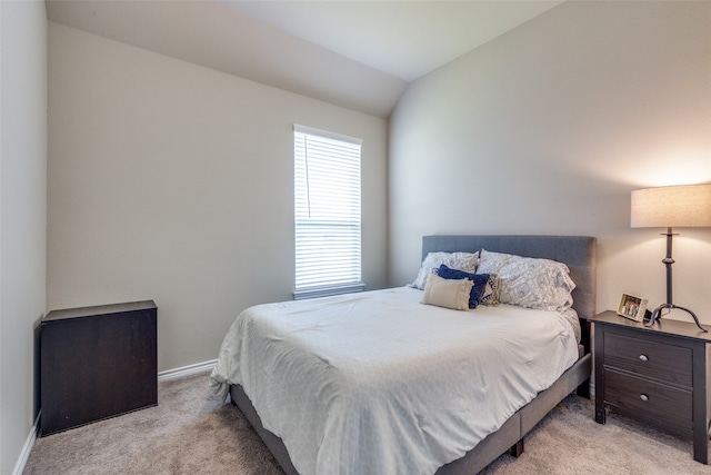 carpeted bedroom featuring lofted ceiling