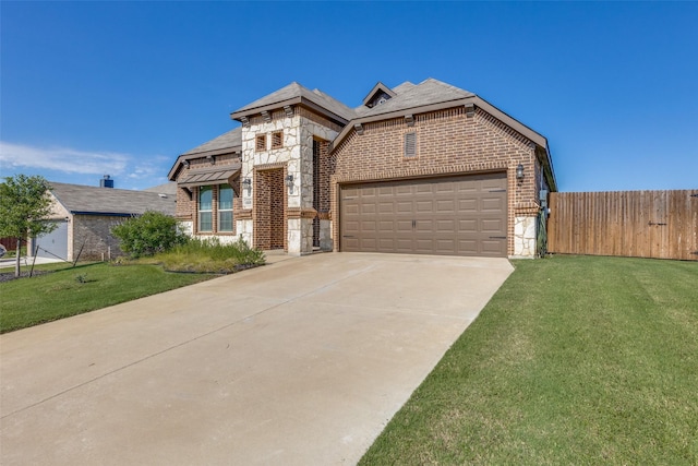 view of front of property with a garage and a front yard