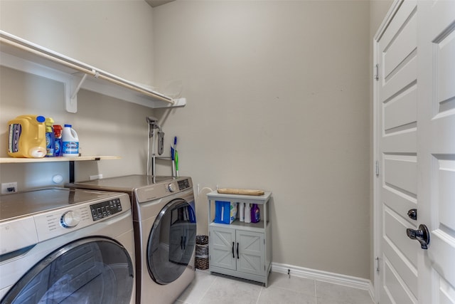 laundry room with washer and clothes dryer and light tile flooring