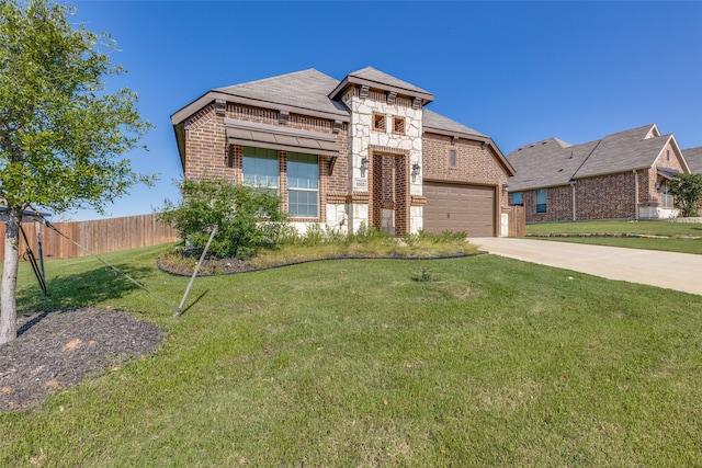 view of front of property with a front lawn and a garage