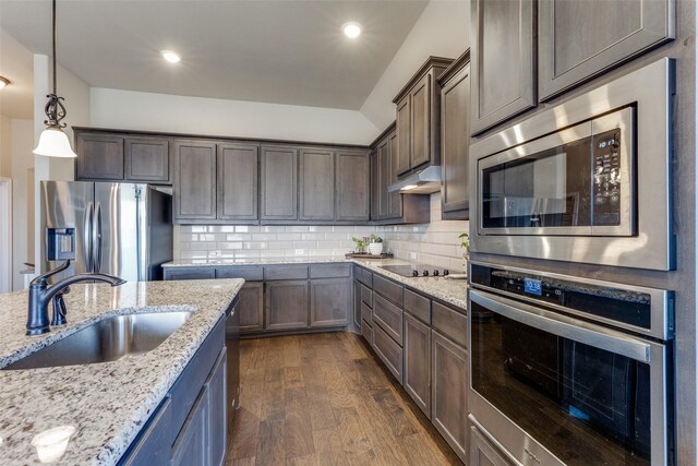 kitchen with decorative light fixtures, dark hardwood / wood-style flooring, stainless steel appliances, backsplash, and sink