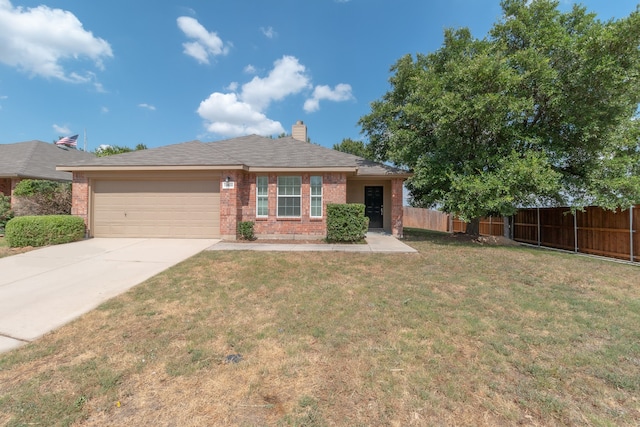 view of front of house with a front yard and a garage