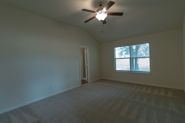 spare room featuring lofted ceiling, ceiling fan, and carpet flooring