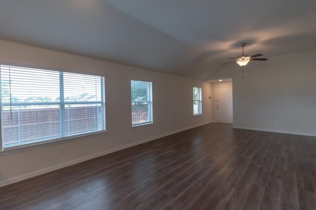 unfurnished room with lofted ceiling, ceiling fan, dark hardwood / wood-style floors, and plenty of natural light