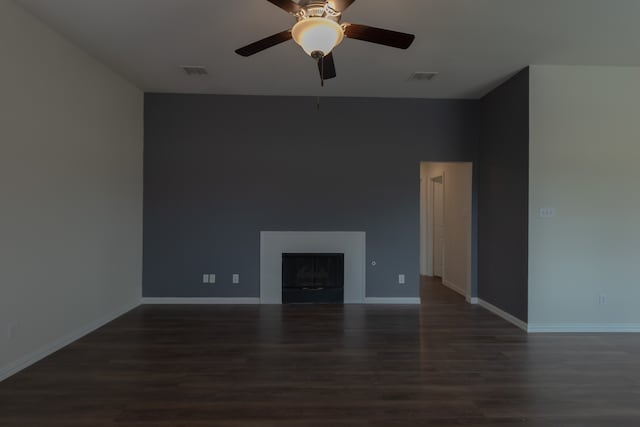 unfurnished living room featuring ceiling fan and dark hardwood / wood-style floors