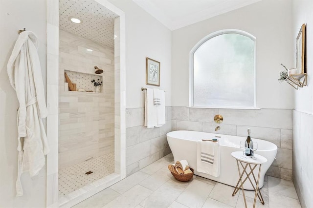 bathroom with tile patterned flooring, shower with separate bathtub, and tile walls