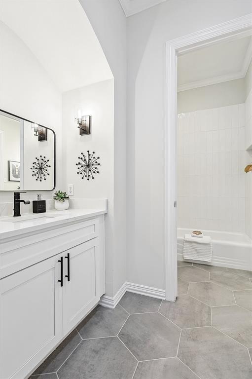 bathroom with tile patterned floors, vanity, and bathing tub / shower combination