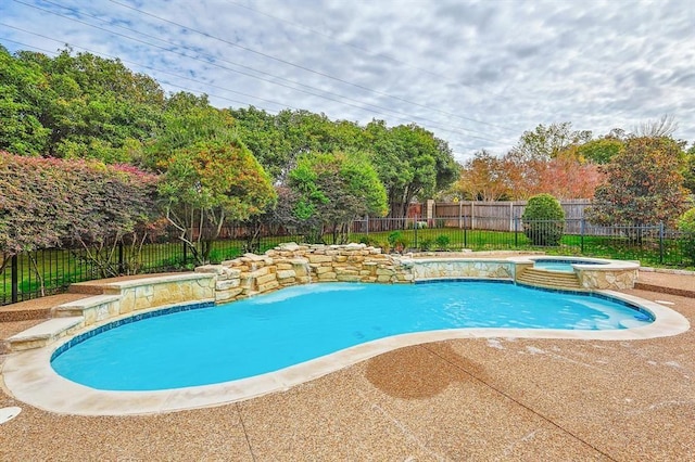 view of swimming pool featuring an in ground hot tub