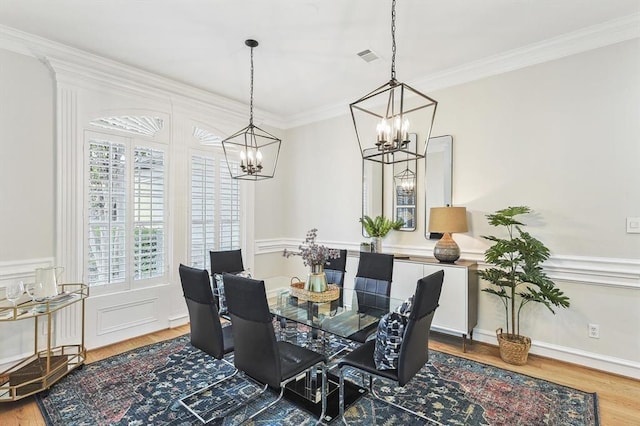 dining room featuring ornamental molding and hardwood / wood-style flooring