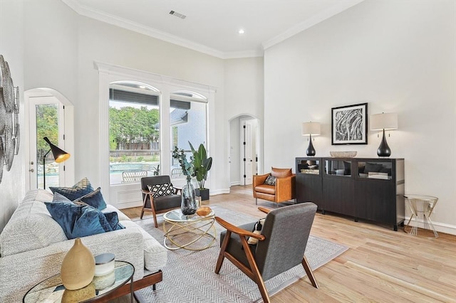 living room featuring crown molding and light wood-type flooring