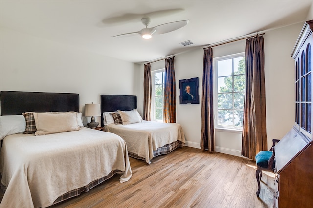 bedroom with ceiling fan and light wood-type flooring