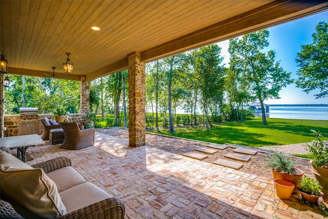 view of patio featuring area for grilling, an outdoor hangout area, and a water view