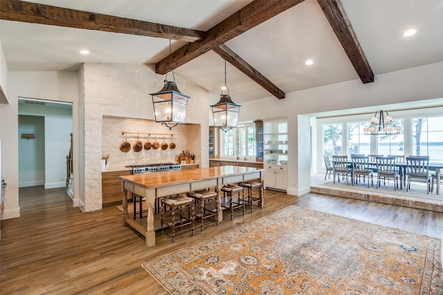 dining area with a notable chandelier, high vaulted ceiling, and hardwood / wood-style flooring