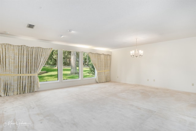 unfurnished room with carpet and an inviting chandelier