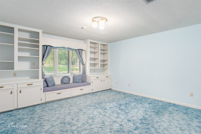 interior space with light carpet and a textured ceiling