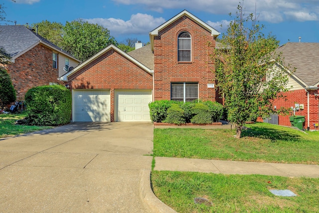 front of property with a front lawn and a garage