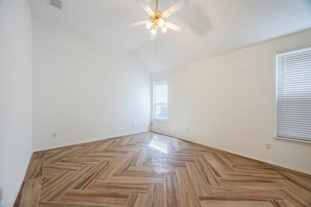 spare room featuring ceiling fan, lofted ceiling, and light parquet floors