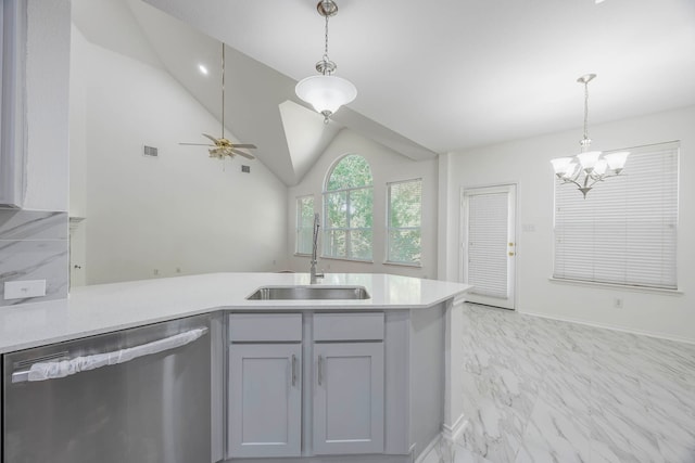 kitchen with pendant lighting, sink, gray cabinetry, stainless steel dishwasher, and vaulted ceiling