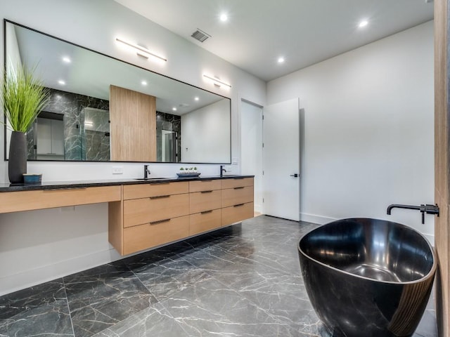 bathroom with vanity and a shower with shower door