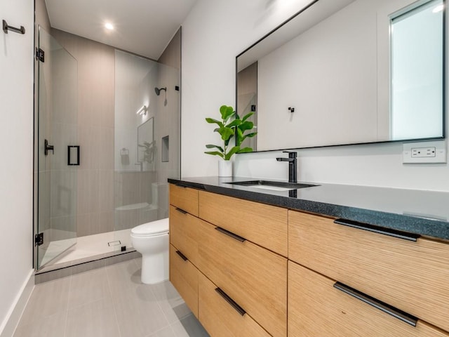 bathroom featuring tile patterned flooring, vanity, toilet, and an enclosed shower