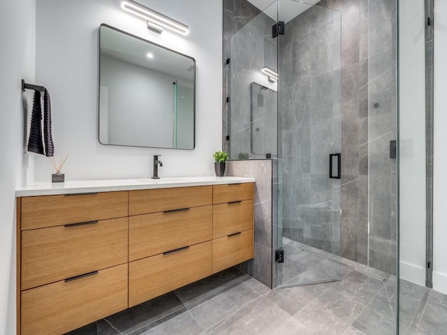 bathroom featuring vanity and a shower with shower door