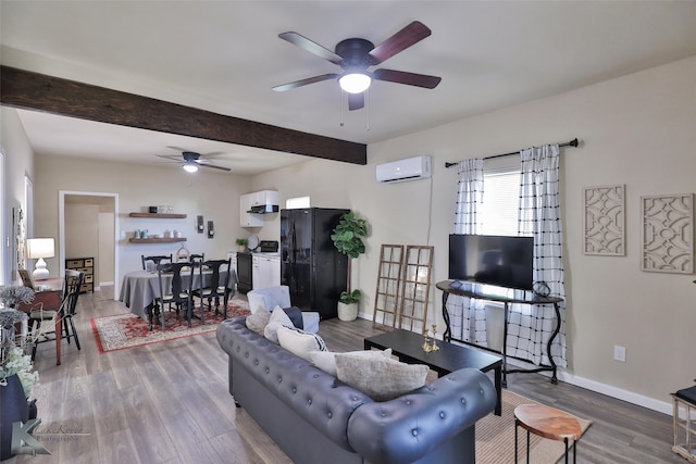 living room featuring beam ceiling, hardwood / wood-style floors, a wall mounted air conditioner, and ceiling fan