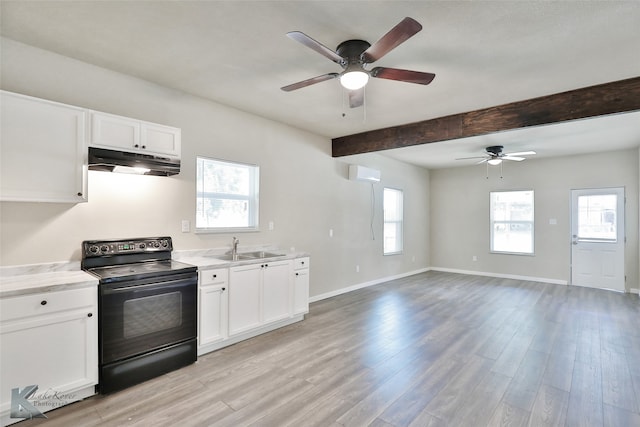 kitchen with a wealth of natural light, black / electric stove, white cabinetry, and light hardwood / wood-style floors