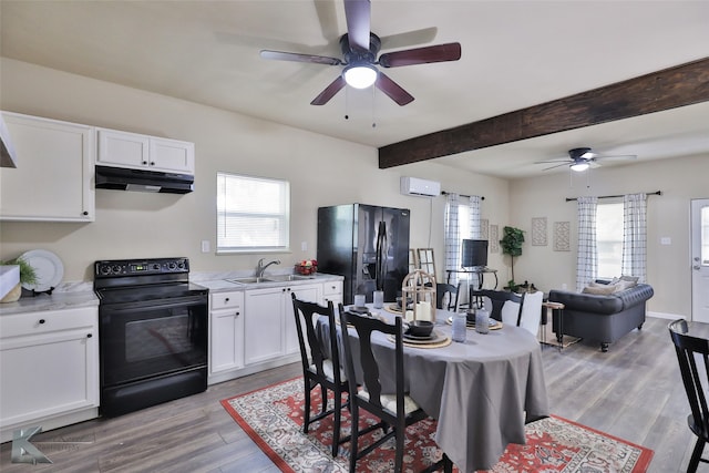 dining room with ceiling fan, a wall mounted air conditioner, light hardwood / wood-style flooring, beamed ceiling, and sink