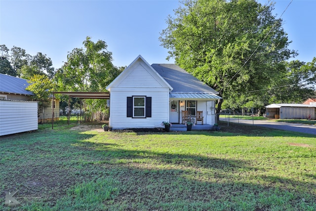 view of front of house with covered porch, a front yard, and a carport