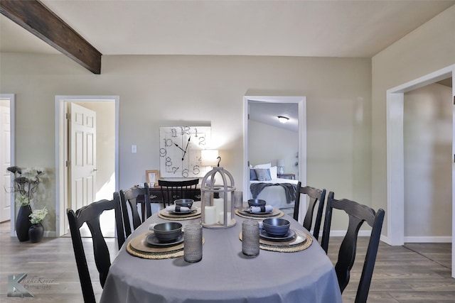 dining area featuring hardwood / wood-style flooring and beamed ceiling