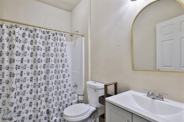 bathroom with vanity, toilet, and a shower with shower curtain