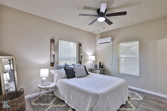 bedroom with a wall mounted AC, ceiling fan, and dark hardwood / wood-style flooring