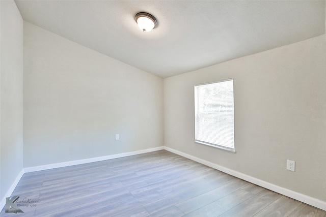 spare room featuring light wood-type flooring